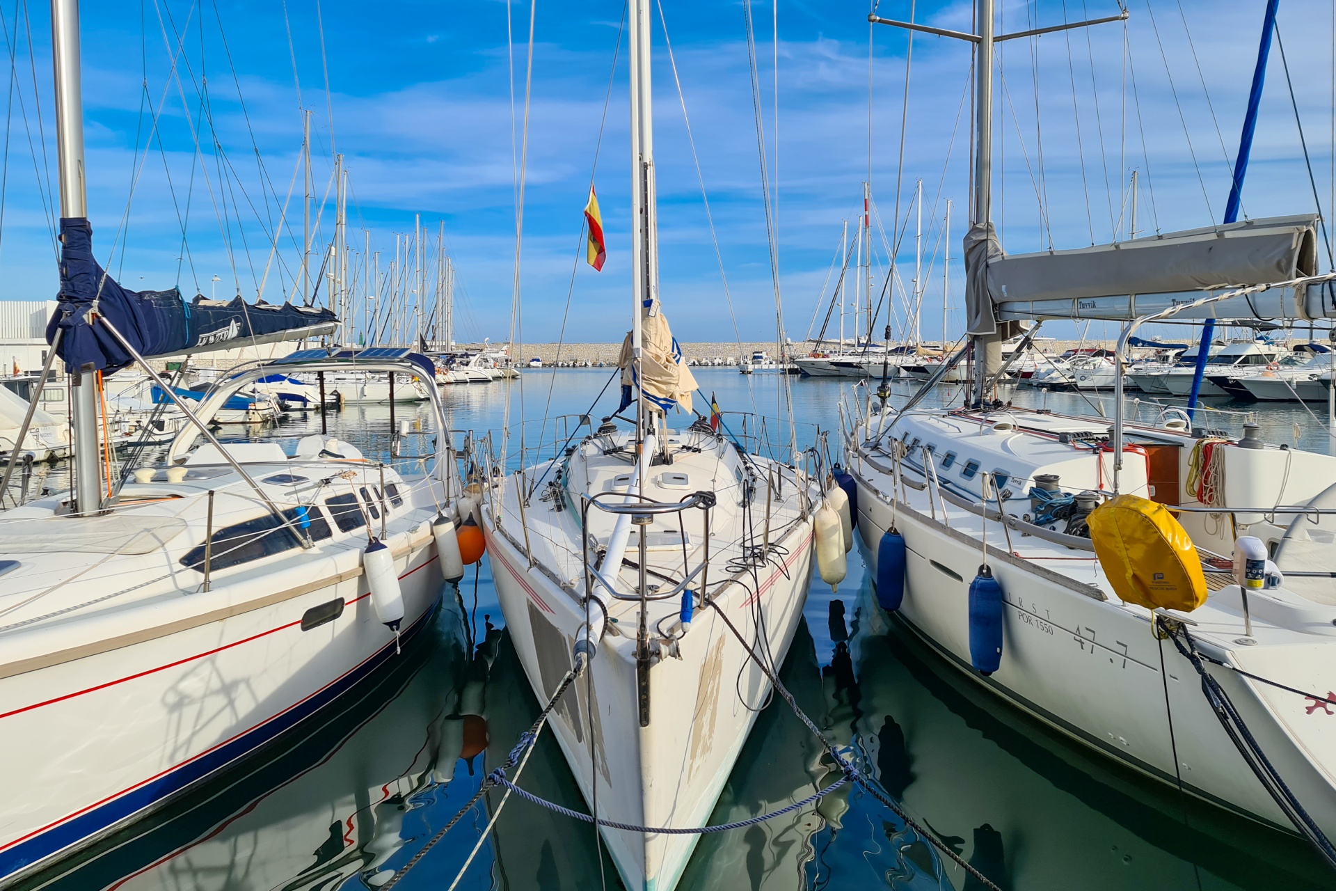 Boats docked tightly together at a marina to maximize slip revenue